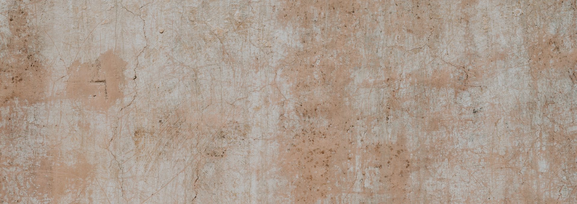 a white and brown wall with a clock on it